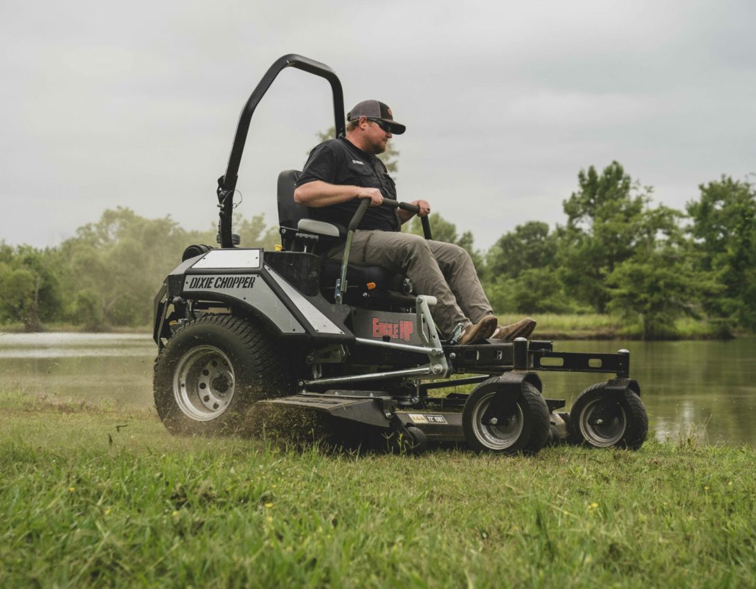 A Dixie Chopper Eagle mowing grass wide open